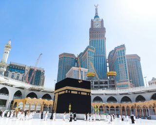 Pilgrims in Kaaba in Macca al Haram - umrah Socially Distanced coronavirus restrictions face mask